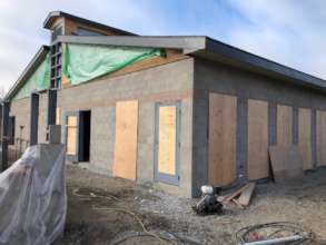 Walls and roof are up on the first building