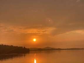 Smoke from the wildfires tints the sky orange