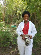 A beekeeper who received a Kiva loan for equipment