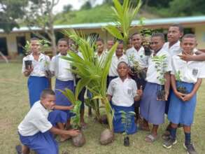 Children participating in tree planting at school