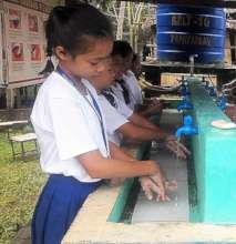 Students wash hands before school lunch