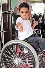 child gives thumbs up for new wheel chair