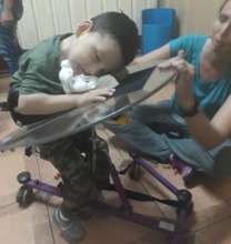 little boy falls asleep as he gets mobility aid