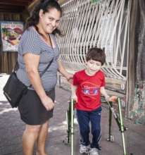 Mother with child receiving specialized Walker