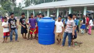 Children excited with 100 gallon rain water tank