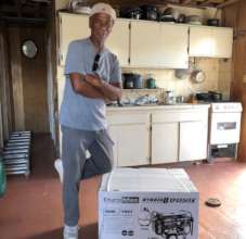 Resident happily poses with his new generator.