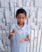 Angelito saying "Gracias" in sign language