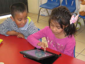 Maricruz learns to use a tablet