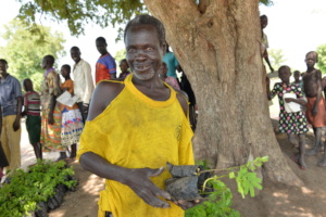 Refugee participant receiving seedlings