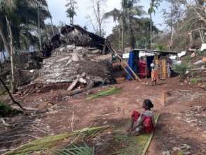 Women weaving coconut leaf for protecting houses