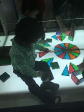 Caden playing at a light table