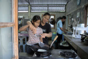 Foster family cooking together