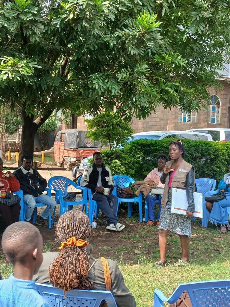 A community Facilitator supporting a group discuss
