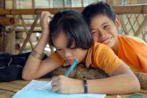 Children completing schoolwork in Thailand