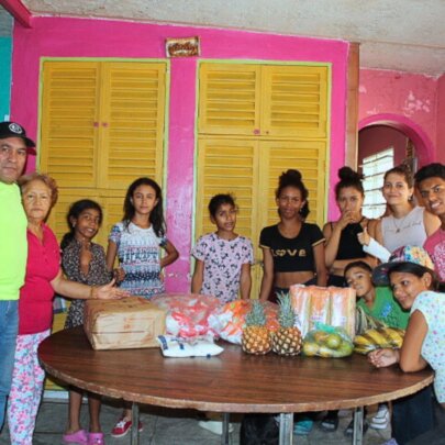 South American Initiative Provides Food for Venezuelan Orphanage The South American Initiative, a dedicated non-profit organization, delivers essential supplies, including food, medicine, and study materials, to orphanages across Venezuela. This image captures children gathered around a table filled with fresh fruits and packaged goods, highlighting the organization's commitment to supporting vulnerable youth through sustainable aid programs.