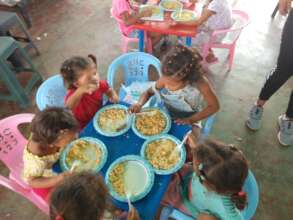 Orphans happily eating nutritious food