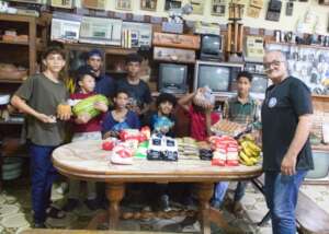 Young boys receiving a food donation from SAI