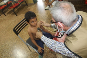 SAI doctor checking vitals for a small orphan boy.