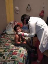 SAI medical assistant examines orphan boy