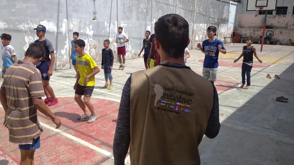 Orphans receiving physical fitness from trainer.