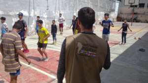 Orphans receiving physical fitness from trainer.