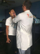 SAI clinic doctor examines teenager at orphanage