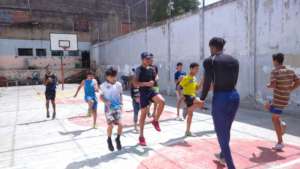 Orphans receiving physical fitness from trainer.