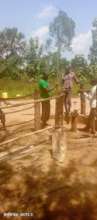 A team supervises repair of community borehole