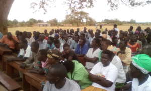 Angic: Community attending meeting