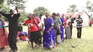 Community dance in joy with their gift
