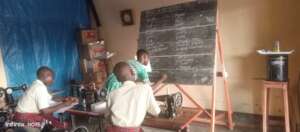 A supervisor gives notes on kitchen items