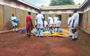 Students sun drying maize after harvest