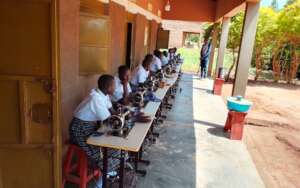 Students are sitting on their sewing machines
