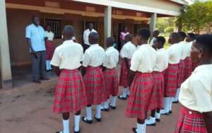 Inspector addressing the school assembly