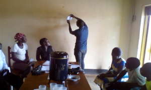 Instructor showing youth how to make sanitary pad