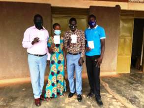 Staff take photos with cards for COVID-19 vaccine