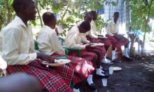 The girls enjoy the meal at poultry unit
