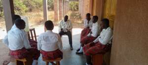 A staff lectures on social norms