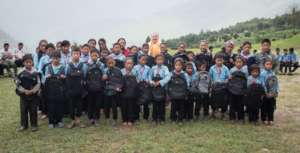 Ellie Raymond taking group pictures with children