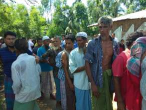 People waiting for their Turn to Receive Food