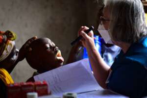 A medtreks nurse conducting a throat check-up