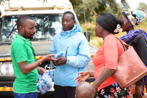 HopeCore's WASH officer distributing waterguard.