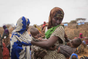 mother with 2 child in earch of food