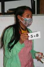 Atzin Educator, Belem, works on basic math skills.
