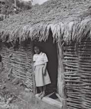 Young girl in the doorway of her home