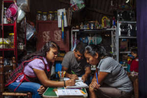 Educator with learners in home-based class.