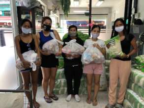 Women picking up food bags
