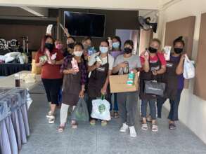 Women receiving donations of cleaning material