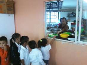 Volunteer Cooks in Elementary School Cafeteria