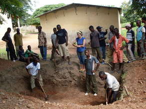 Volunteers are digging the hole for toilets